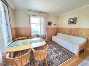 a bedroom with a bed and a table and chairs at Agda's Garden in Sulkava