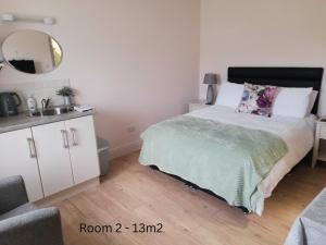 a bedroom with a bed with a sink and a mirror at Lakeside Loughrea in Loughrea