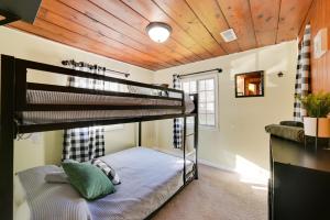 a bedroom with bunk beds in a house at Houghton Lake Cottage - Central Location! in Houghton Lake