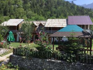 a house with a garden in front of it at Zariklis in Theth +12 photos