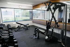 a gym with treadmills and machines in a room at Hôtels Gouverneur Sept-Îles in Sept-Îles
