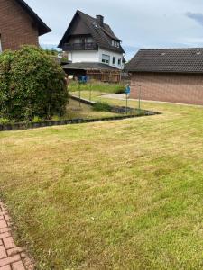a yard with a house in the background at Ferienhaus fussläufig vom Biggesee in Attendorn