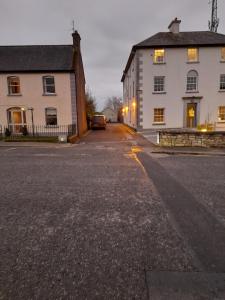an empty street in front of a white building at Lakeside Loughrea in Loughrea