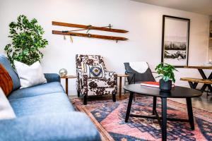 a living room with a blue couch and chairs at Tucker's Place in Revelstoke