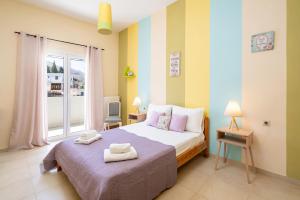 a bedroom with a bed with two towels on it at Krystallenia's House in Zekros