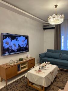 a living room with a couch and a table at Suite Debussy in LʼAgha