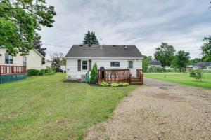 a white house with a fence and a yard at Charming Pepin Home Near Mississippi River! in Pepin