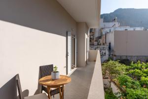 a balcony with a table and chairs on a building at Krystallenia's House in Zekros
