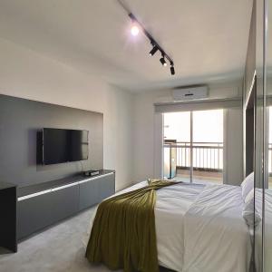 a bedroom with a bed and a flat screen tv at Studio Prime 1510 - Higienópolis in Sao Paulo +16 photos