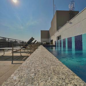 a swimming pool in front of a building at Studio Prime 1510 - Higienópolis in Sao Paulo