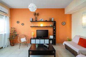 a living room with an orange wall at Krystallenia's House in Zekros