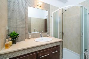 a bathroom with a sink and a shower at Krystallenia's House in Zekros +20 photos