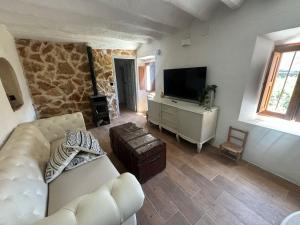 a living room with a couch and a flat screen tv at Casas Navalón in Albacete