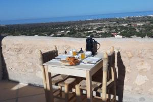 a table with a plate of food sitting on top of a table at Dar Edouard in Sidi Kaouki