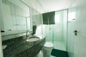 a bathroom with a sink and a toilet and a shower at Pousada Pingo d' Água in Bombinhas +23 photos