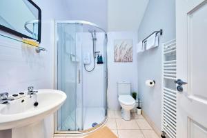 a bathroom with a shower and a sink and a toilet at West Beach 5 - Portrush by the Sea in Portrush +59 photos