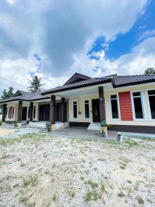 a home with a red and white house at Ar-Rayyan 2 Homestay Kota Bharu in Kota Bharu