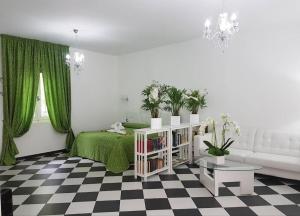 a living room with a green bed and a couch at Giada in Gussago