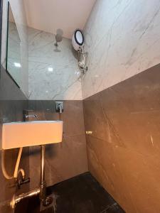 a bathroom with a sink and a mirror at Parel Residency in Mumbai