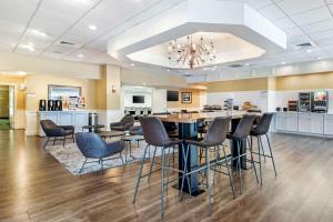 a dining room and kitchen with a table and chairs at Best Western Springfield Hotel in Springfield
