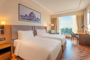 Grand Mirage Dhanbad, a member of Radisson Individuals客房内的一张或多张床位