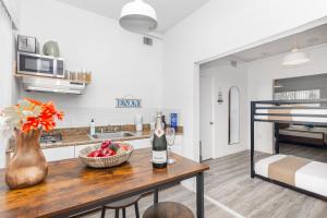 a kitchen with a table with a bowl of fruit at West Deco in Miami Beach