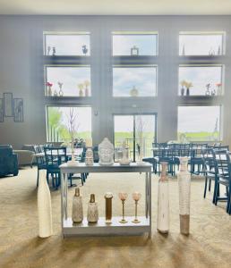a room with a table with vases on it at Qube Hotel - Polk City in Polk City +37 photos