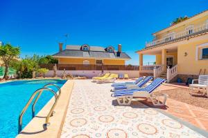 a villa with a swimming pool and a house at Stunning Central Villa Rosa in Ciudad Quesada Rojales Spacious 4-Bedroom Retreat with Private Pool in Ciudad Quesada