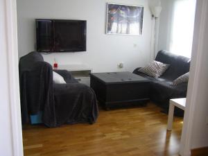 a living room with a couch and a flat screen tv at Vistas de Ronda in Ronda