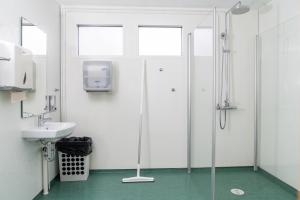 a bathroom with a shower and a sink at Vogar Travel Service in Myvatn