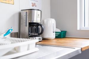 a coffee maker sitting on top of a kitchen counter at Vogar Travel Service in Myvatn