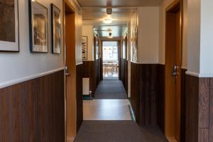 a corridor of a hallway with wooden doors and a hallway at Vogar Travel Service in Myvatn