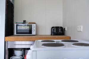 a kitchen with a white stove and a microwave at Vogar Travel Service in Myvatn