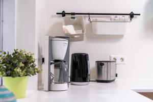 a kitchen counter with three coffeemakers on it at Vogar Travel Service in Myvatn