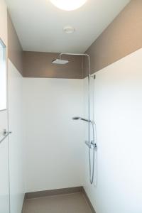 a shower in a bathroom with a ceiling at Vogar Travel Service in Myvatn