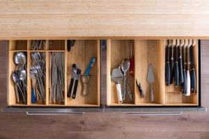 a wooden drawer with utensils in it at Vogar Travel Service in Myvatn