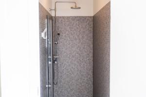 a shower with a glass door in a bathroom at Vogar Travel Service in Myvatn