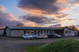 a group of cars parked in front of a building at Vogar Travel Service in Myvatn