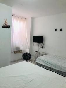 Ένα ή περισσότερα κρεβάτια σε δωμάτιο στο Lindo flat no recreio dos bandeirantes(gilka machado)