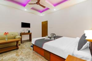 a bedroom with a bed and a couch and a tv at Hotel D N Grand in Rānchī