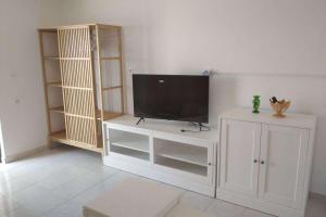 a white entertainment center with a flat screen tv at Apartments with parking space Murvica, Brac - 23462 in Bol