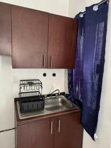 een kleine keuken met een spoelbak en een aanrecht bij Bienvenidos a tu segundo hogar! in Altamira