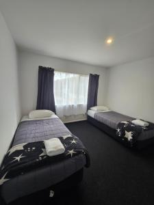 Postel nebo postele na pokoji v ubytování Greenwood Park Motel