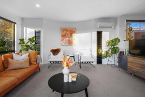 a living room with a couch and a table at Overdale Oasis in Christchurch