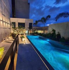 a swimming pool in front of a building at Cozy apartment with terrace, SJ Cosmopolitan Tower #402 in San José