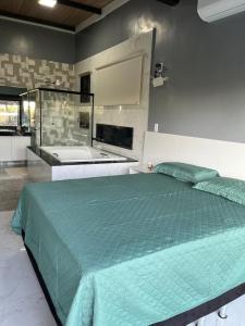 a bedroom with a large bed and a bath tub at Terra Santa - Condomínio Monte Hermon in Trindade