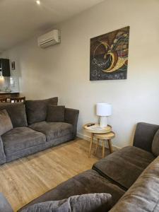 a living room with a couch and a table at Central Shepparton Apartment 13 in Shepparton