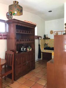 a kitchen with a large wooden cabinet in a room at Hermosa Casa de Campo in El Varal +10 photos