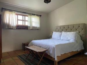 a bedroom with a large bed and a window at Hermosa Casa de Campo in El Varal
