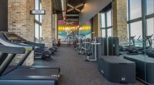 a gym with a row of treadms and cardio machines at Apartment in Miami downtown in Miami